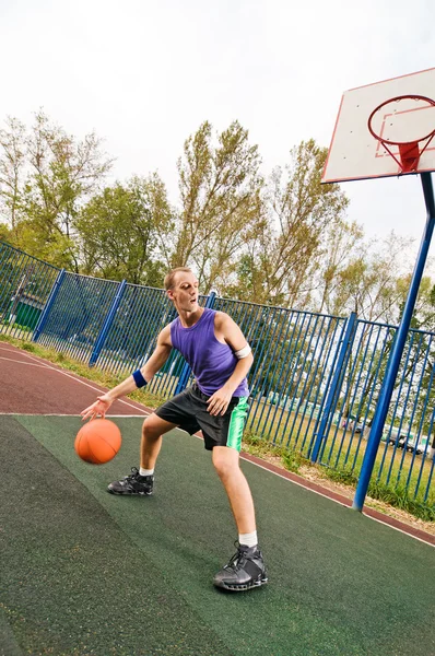 Young men playing street basketball at court playground — Stock Photo, Image