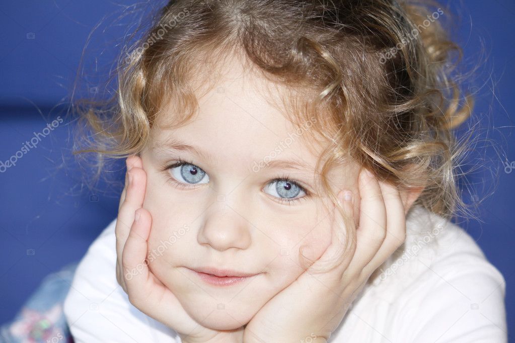 Child with hands cupped on face