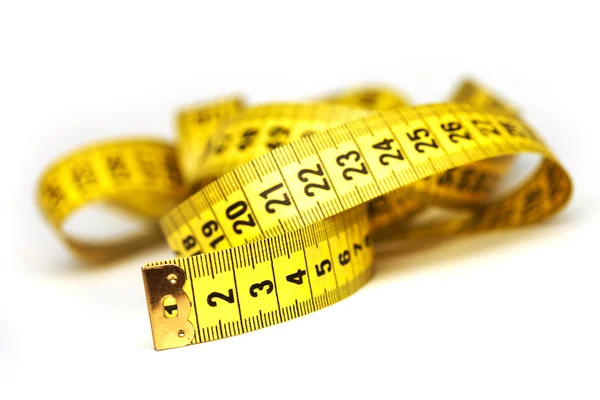 Whirled yellow tape measure — Stock Photo, Image