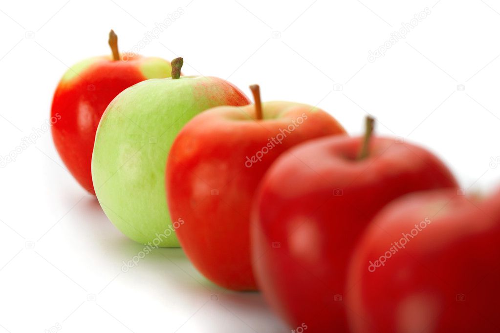 Group of red apples with one green one