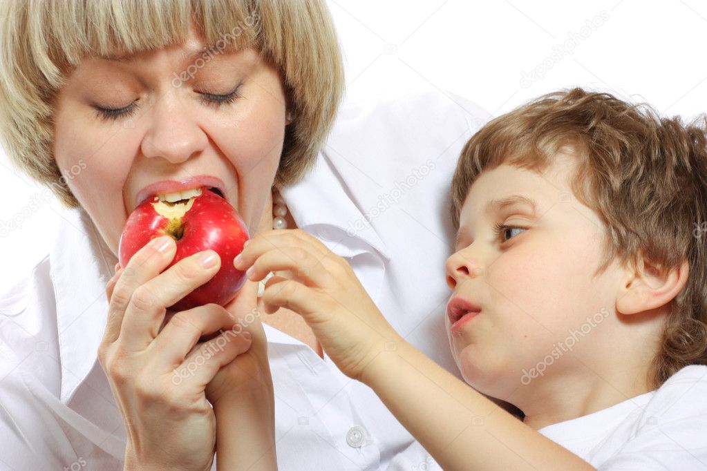 Woman and boy eating apple