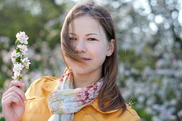 Jonge vrouw in bloeiende park — Stockfoto