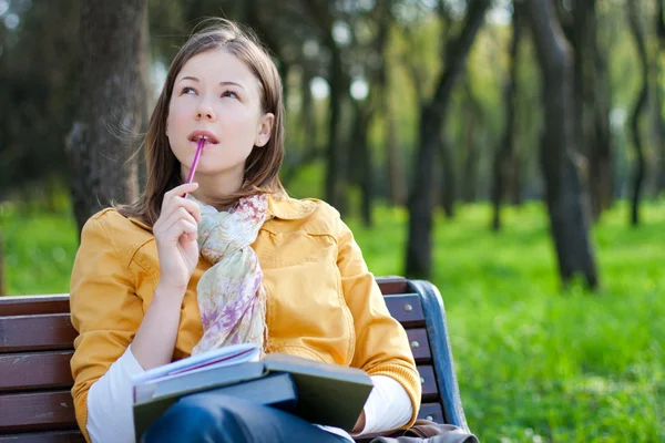 Woman with book in park — Stock Photo, Image