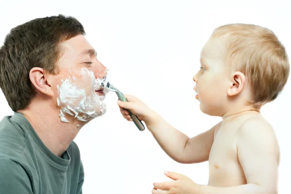 Мальчик бреет отца — стоковое фото