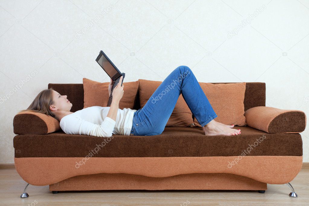 Woman with laptop on the sofa