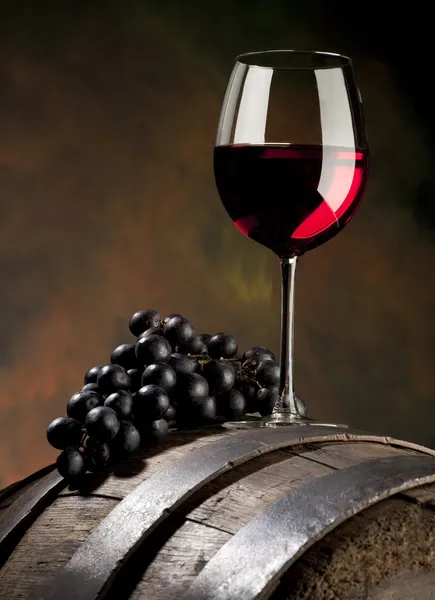 Still life with red wine and old barrel Stock Photo