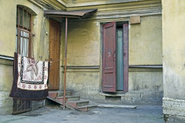 Doorway to old apartment building in city outskirts clipart