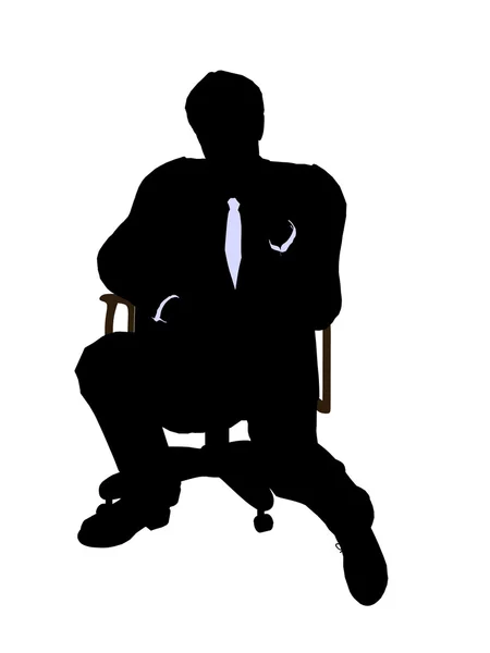 Man klädd i en kostym som sitter i en stol — Stockfoto