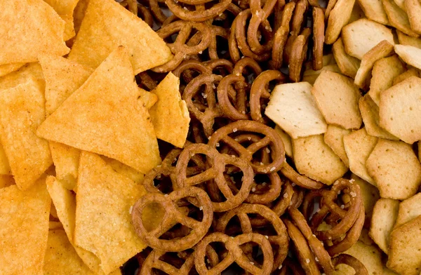 Tortilla chips, pretzels and crackers — Stock Photo, Image