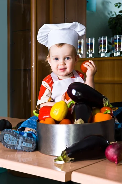 Little boy chef in the kitchen pot — Stock Photo, Image