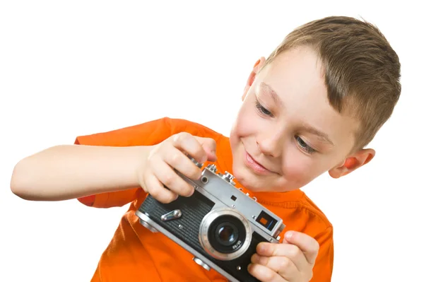 Grazioso ragazzo tiro con fotocamera oltre bianco Immagini Stock Royalty Free