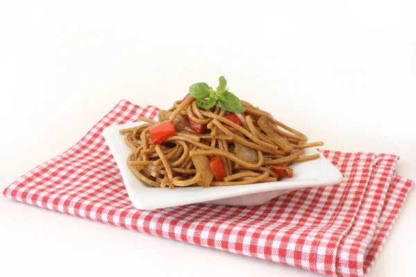 stock image Fried noodles with vegetables and basil
