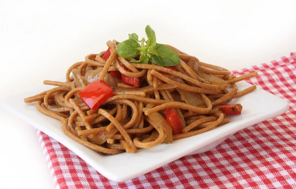 stock image Fried noodles with vegetables and basil