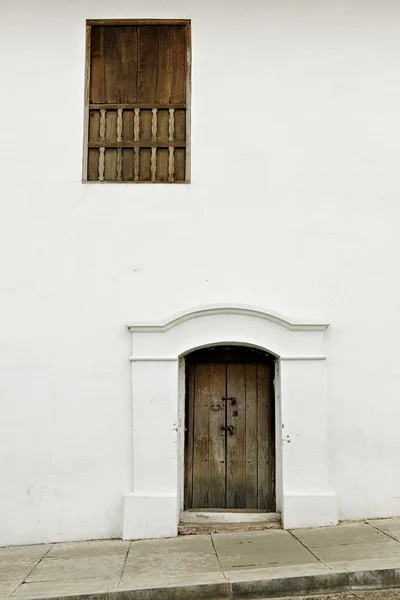Wooden door and window in white wall — Stock Photo, Image