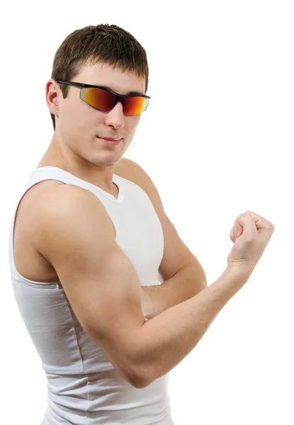 Starker junger Mann im weißen T-Shirt mit Sonnenbrille Stockbild