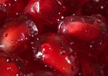 Extreme close up background of a red juicy ripe pomegranate fruit seeds clipart