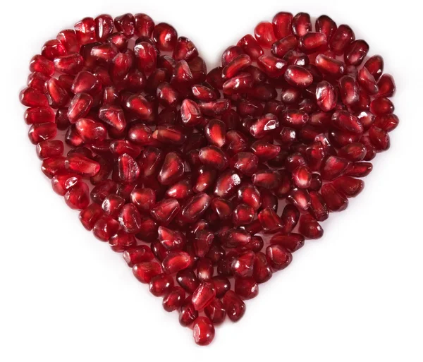 Heart shaped pomegranate seeds, high key — Stock Photo, Image