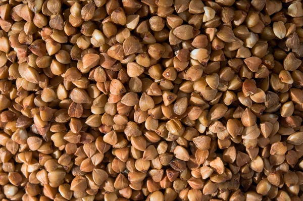 Pattern generated by dry golden buckwheat groats — Stock Photo, Image
