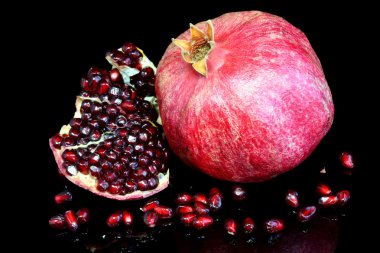 Pomegranate on black. clipart