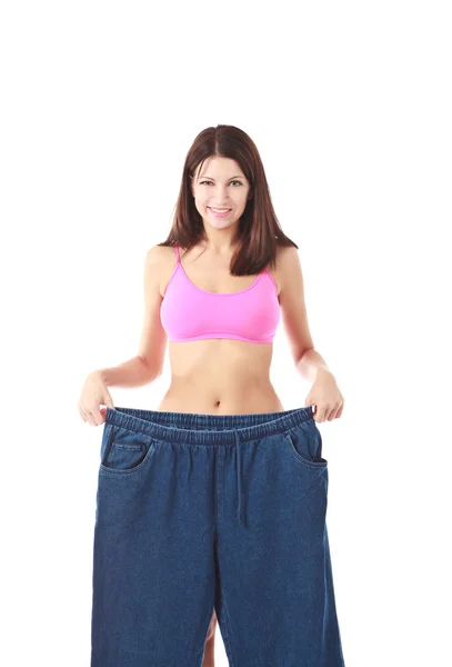 Donna che mostra quanto peso ha perso Fotografia Stock