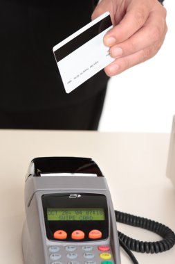 Man paying with card at checkout clipart