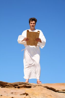 Man in traditional robe reading scroll clipart