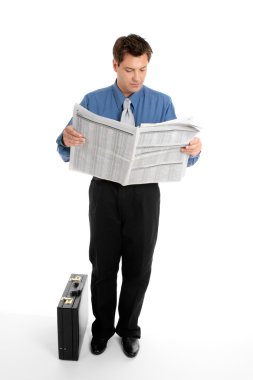 Businessman reading newspaper clipart