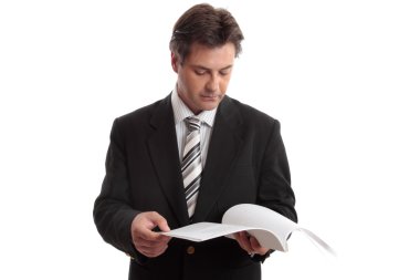 Businessman reading report or document clipart