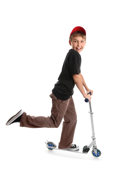 Kind rijden een scooter en glimlachen — Stockfoto
