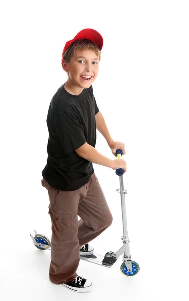 Boy standing beside a scooter — Stock Photo, Image