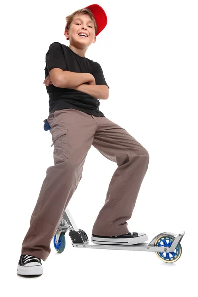 Menino sentado guiador scooter — Fotografia de Stock