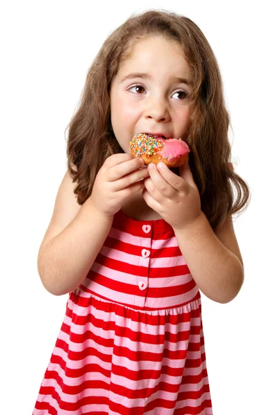 年轻的女孩吃甜甜圈 — 图库照片