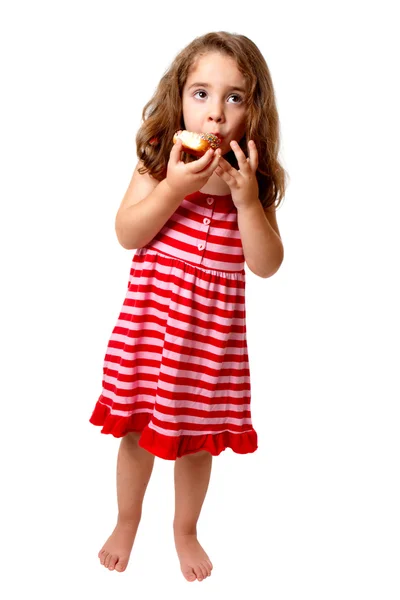 Menina comendo doce donut — Fotografia de Stock