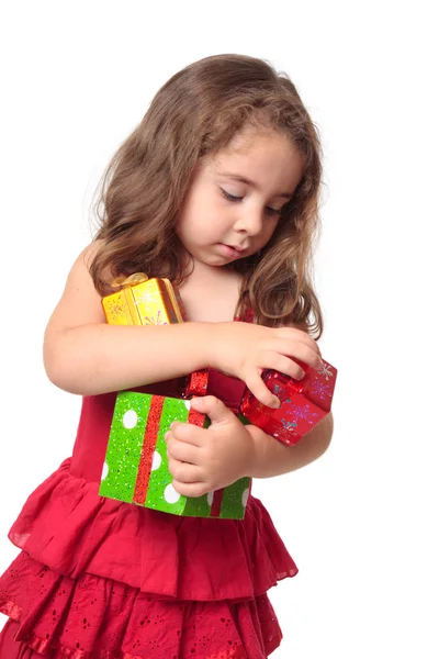 Meisje hold armful van Kerstcadeaus Stockfoto