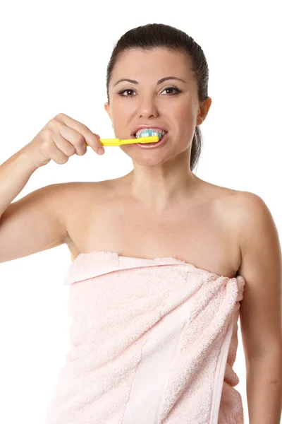Female brushing her teeth with tooshpaste and to — Stock Photo, Image