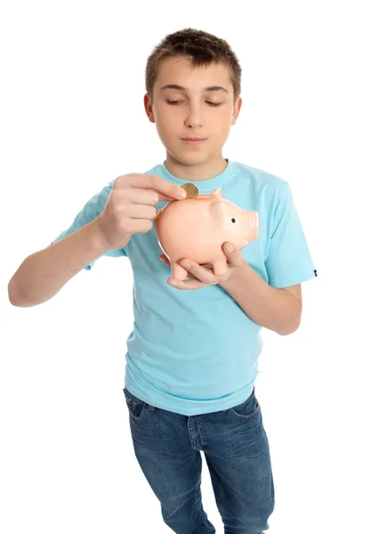 Child placing coins into a piggy bank — Stock Photo, Image