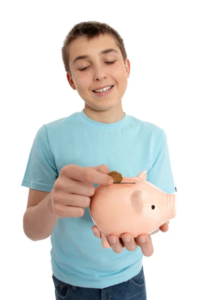 Boy dropping coin into money box — Stock Photo, Image