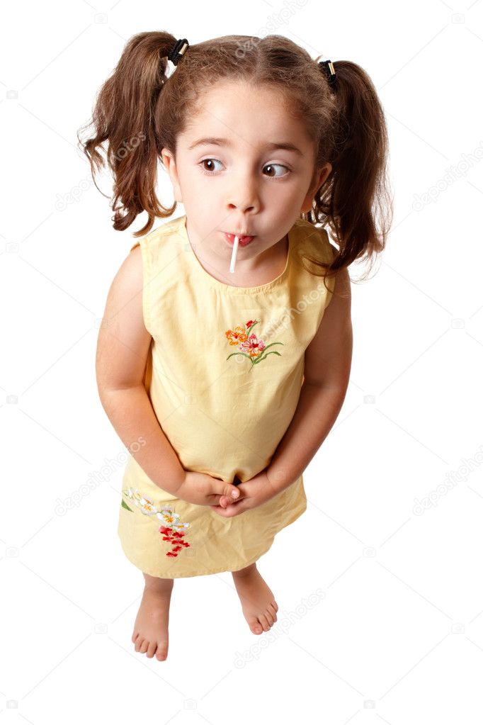 Cute girl sucking on a lollipop candy