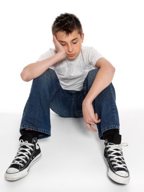 Sad, loney, depressed or listless boy sitting clipart
