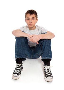 Pre teen boy sitting on floor clipart