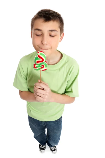 Niño sosteniendo un dulce delicioso caramelo de Navidad — Foto de Stock