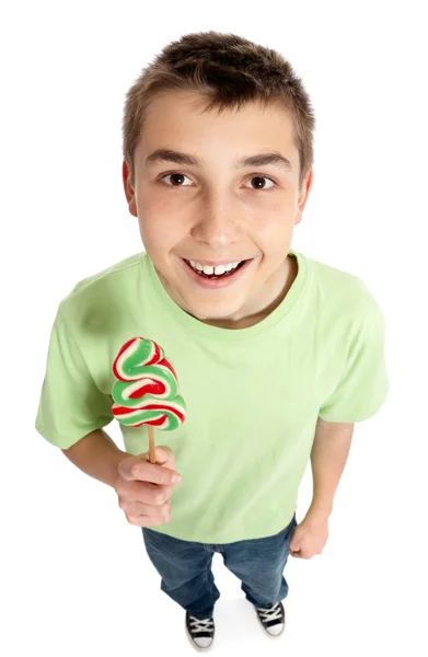 Lycklig pojke håller en slickepinne godis — Stockfoto