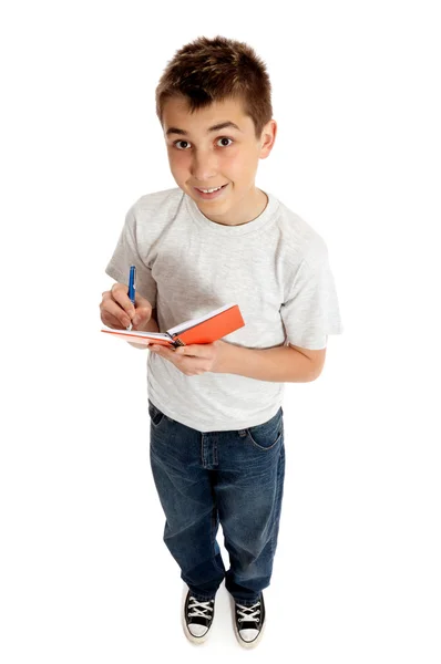 Boy looking up from a book and smiling — Stock Photo, Image