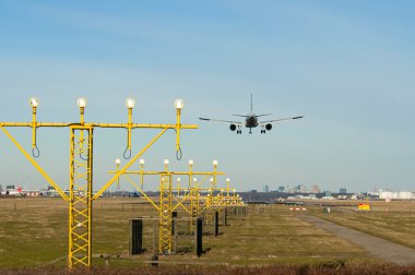 Landing airplane with lights clipart