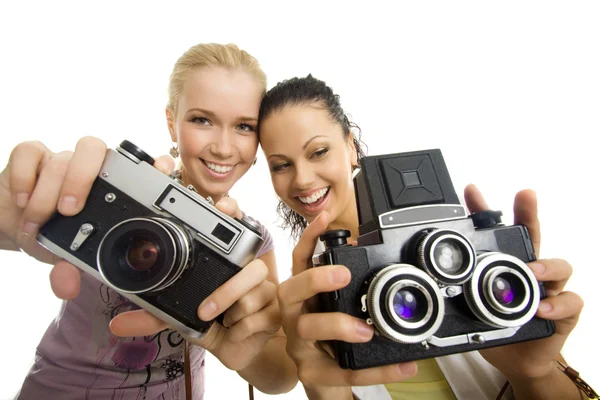 stock image Two woman have fun with camera isolated