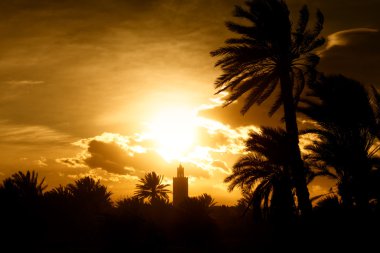 Minaret of a mosque at sunset clipart