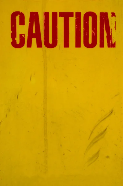 Een grungy gele voorzichtigheid teken — Stockfoto