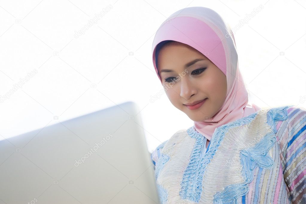 Muslim young girl play with notebook