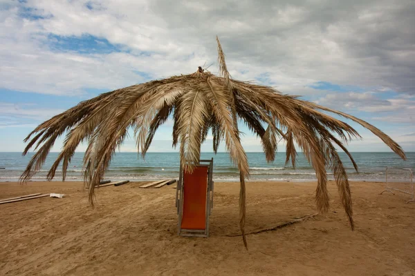 stock image Big umbella and a deckchair