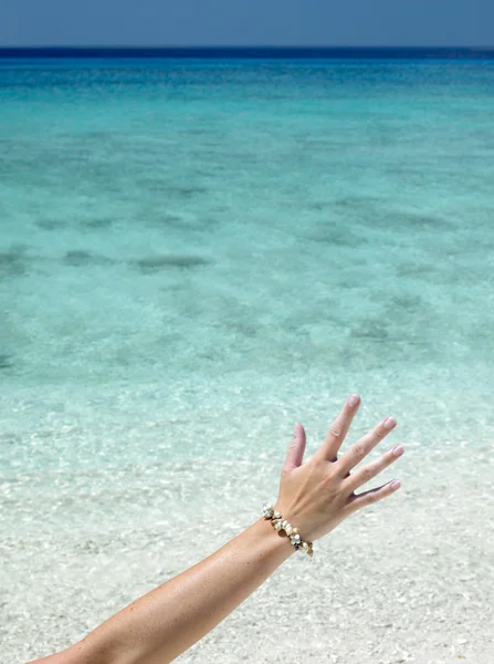Hand with shell bracelet — Stock Photo, Image